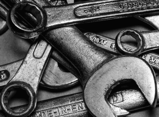 Close-up of a pile of metal wrenches.