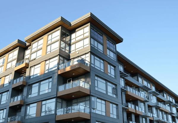 Modern apartment building with balconies and large windows.