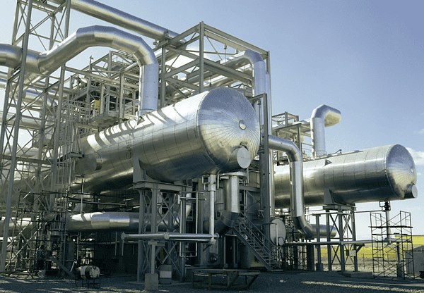 Large industrial tanks and pipes in a processing facility.