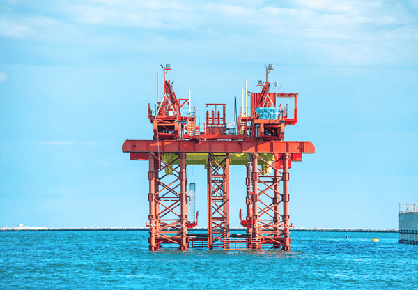 An offshore oil platform in the middle of the ocean.