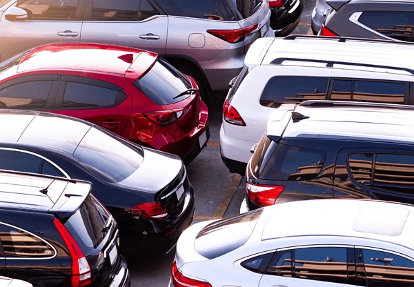 Parking lot filled with cars, highlighting the use of Q355B wind and solar steel in automotive construction.