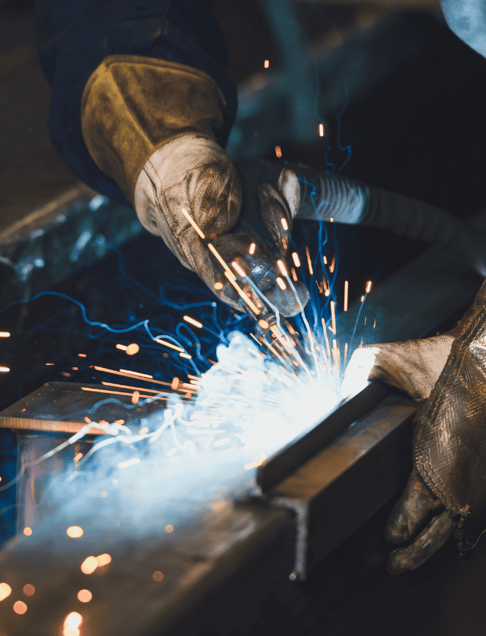 Close-up of a welder working with sparks flying.