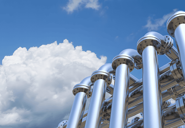 Shiny X70 pipeline steel pipes against a blue sky with clouds.