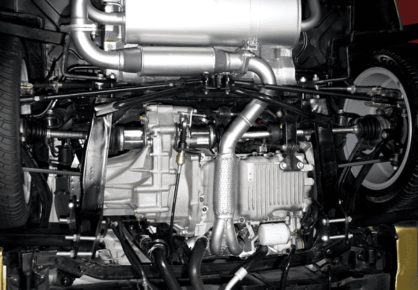 Close-up view of a vehicle's undercarriage, highlighting the exhaust system and mechanical components.