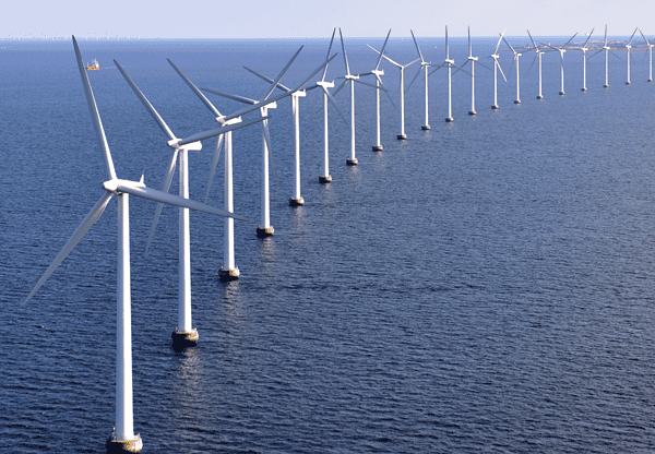 Row of offshore wind turbines in the ocean.