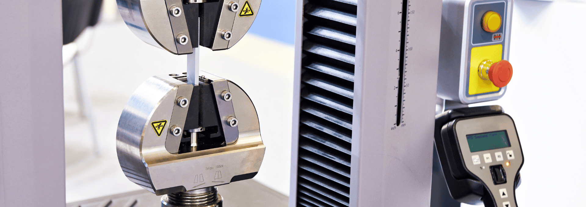 A high-strength steel bar undergoing a tensile test, showcasing the precise measurement of its tensile strength and mechanical properties in a laboratory setting.