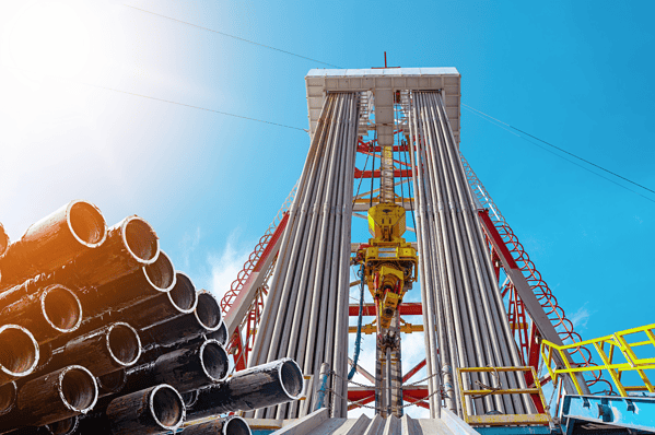 View of an oil drilling rig with pipes and equipment.