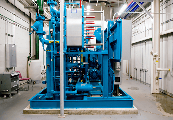 Industrial blue machinery in a large, well-lit indoor facility.