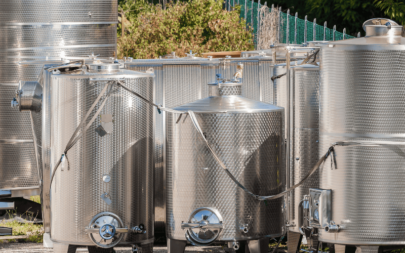 Stainless steel tanks in an outdoor setting.