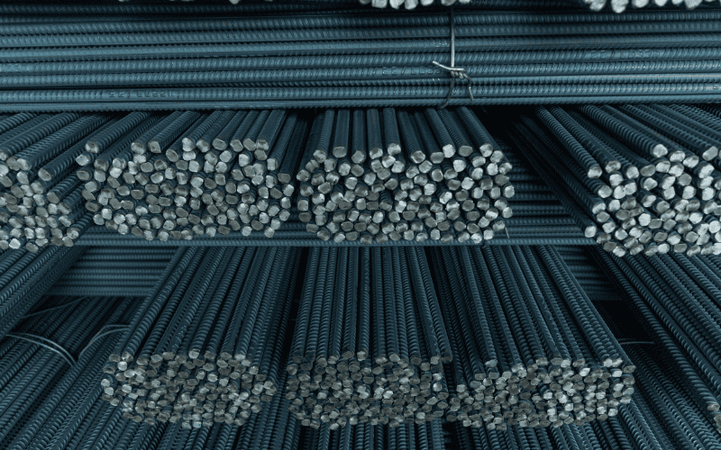 Stacks of rebar rods in a warehouse.