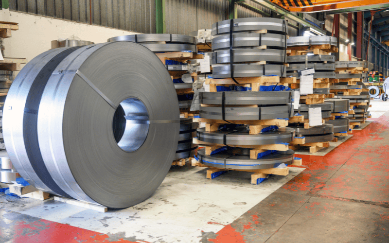 Rolls of stainless steel in a storage area.