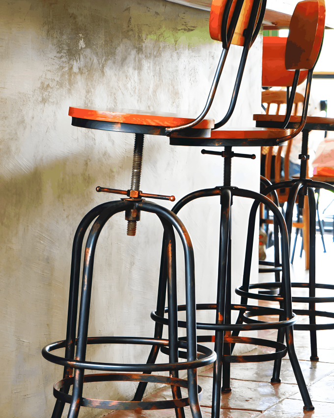 Bar stools with frames made from cold rolled steel bars, providing sturdy and stylish seating in a modern café setting.