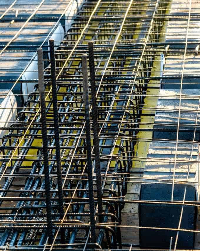 Cold rolled steel bars being used as reinforcement in a construction project, showcasing their strength and structural integrity.