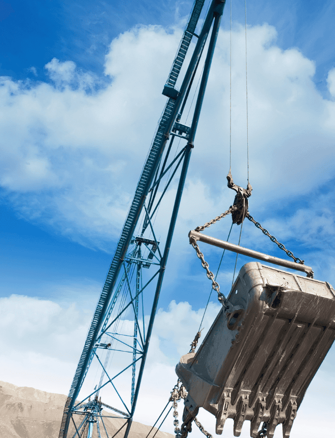 Construction crane lifting a large container, made with hot rolled steel bars.