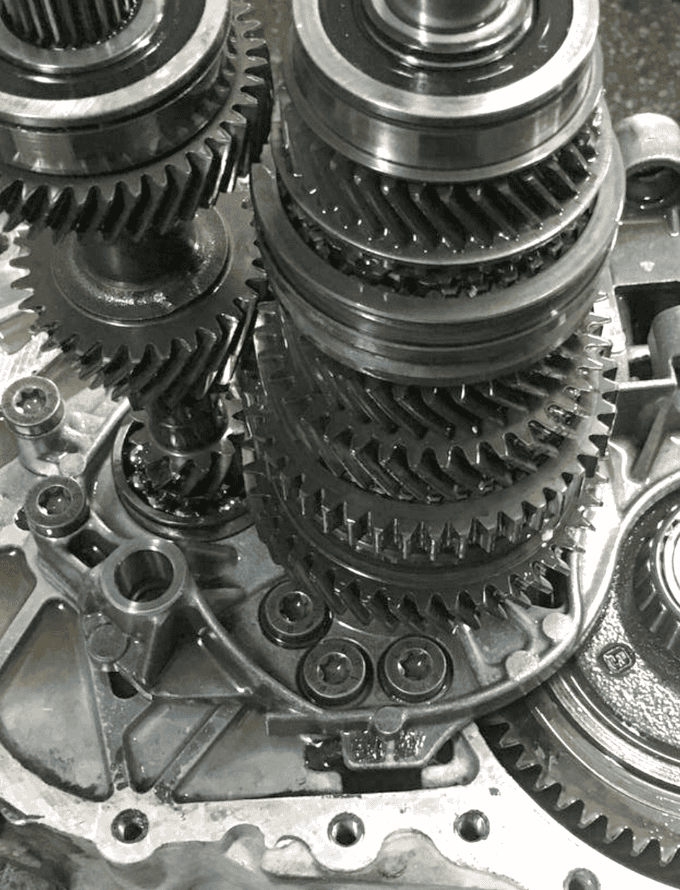 Close-up of mechanical gears and components, featuring hot rolled steel bars in the assembly.