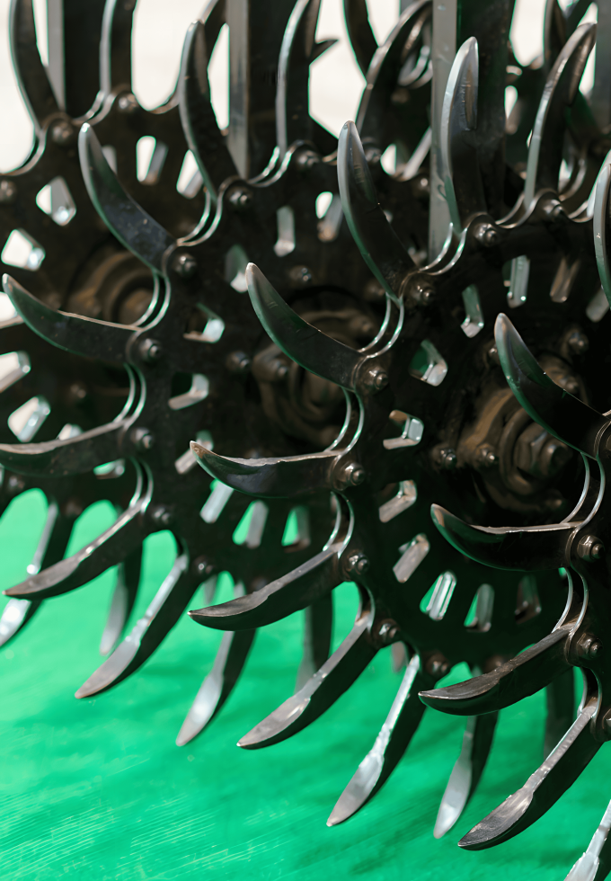 A close-up of spiked agricultural equipment, featuring the intricate design of plain carbon steel bars used in the machinery.