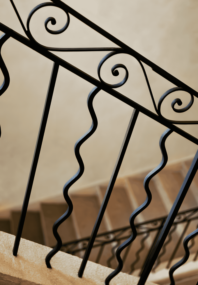 A decorative stair railing made of plain carbon steel bars, showcasing intricate and elegant designs.