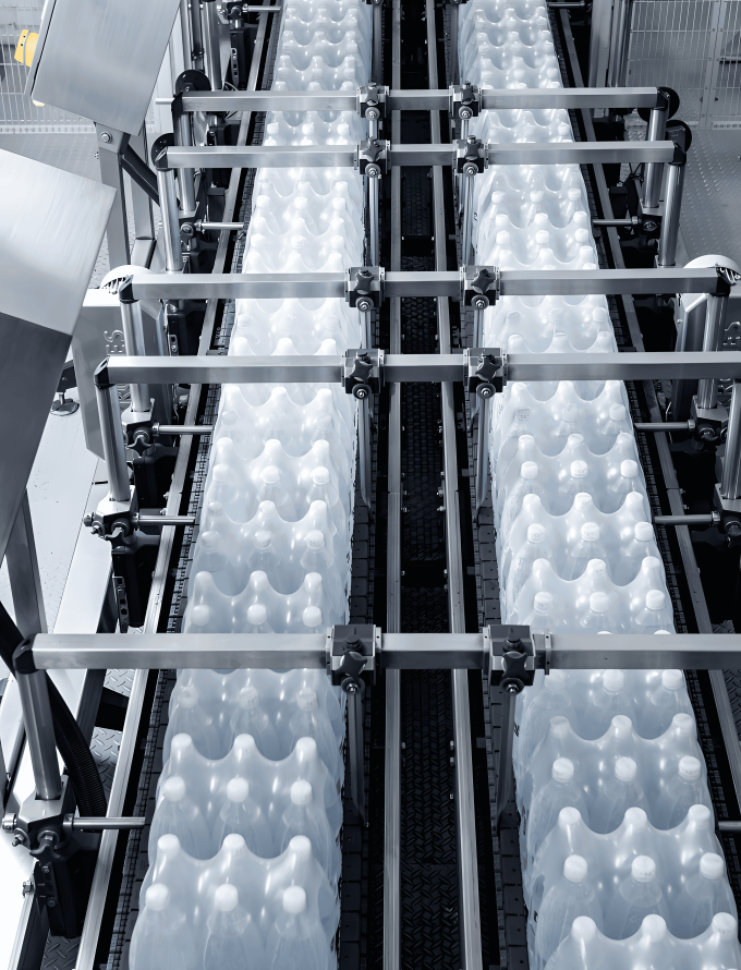 A production line with stainless steel bars in a factory, highlighting the manufacturing process and precision engineering involved.