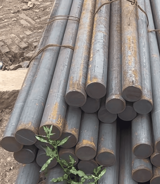 Medium carbon steel bars stacked for machining and heavy-duty uses.