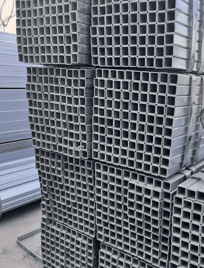 Piles of medium carbon steel square tubes for versatile construction purposes.