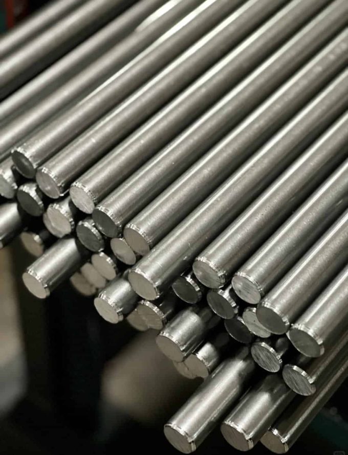 Close-up view of stacked high strength steel bars with a shiny, cylindrical finish, highlighting their uniform shape.
