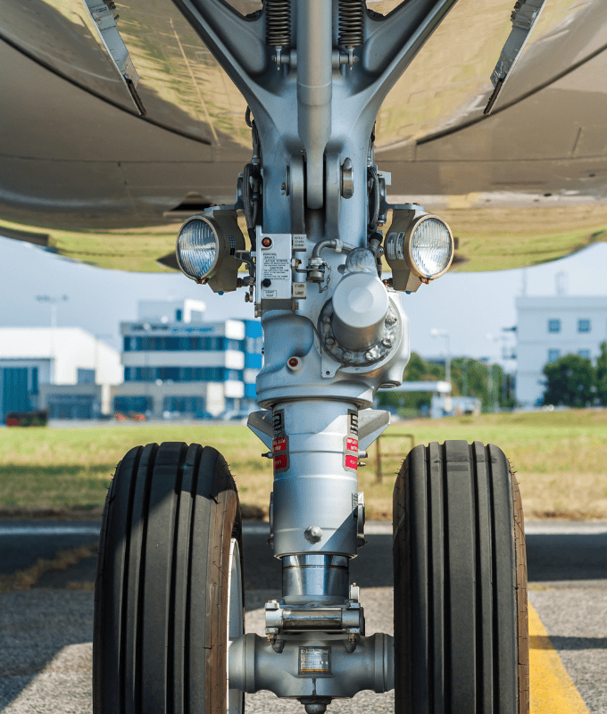 A close-up view of an aircraft's landing gear showcasing the high strength steel bars and components essential for structural integrity and performance.