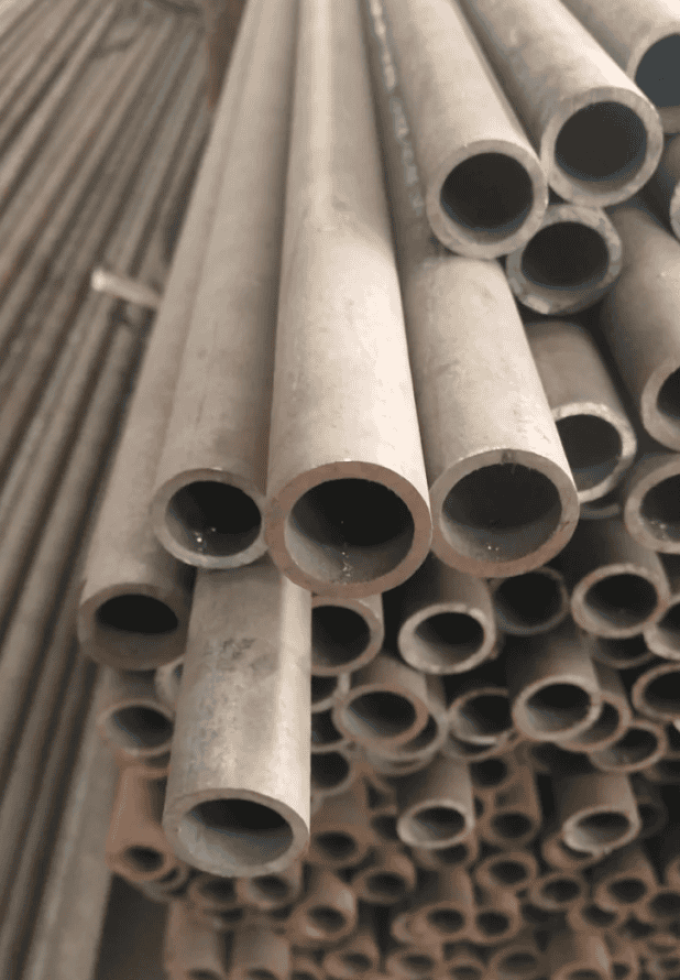 Hot rolled steel pipes placed for storage, showing their cylindrical shape and smooth finish.