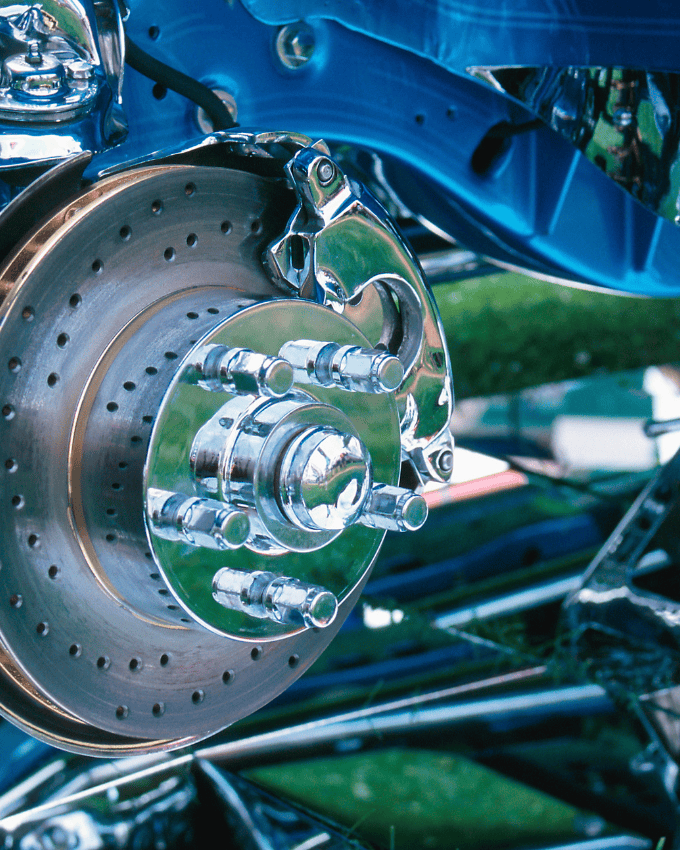 Close-up of a car's polished brake disc and caliper.