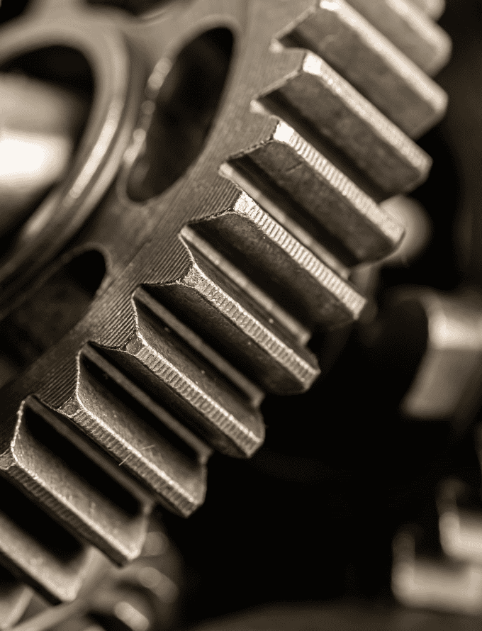 Close-up of a large, metallic gear showing detailed teeth structure.