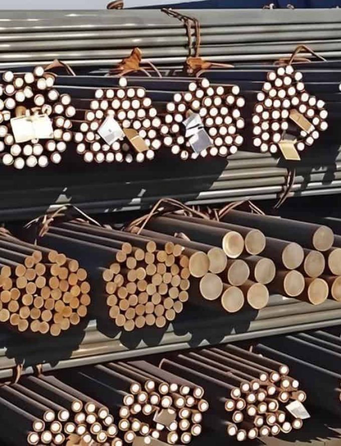Bundles of plain carbon steel rods tied and arranged in rows.