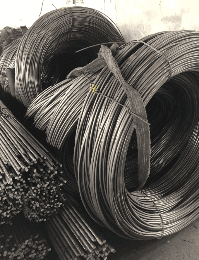 Coiled plain carbon steel wire rods, used in manufacturing and construction projects.
