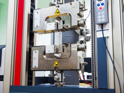 This image shows a tensile testing machine, commonly used to evaluate the strength and ductility of materials by applying controlled tension.