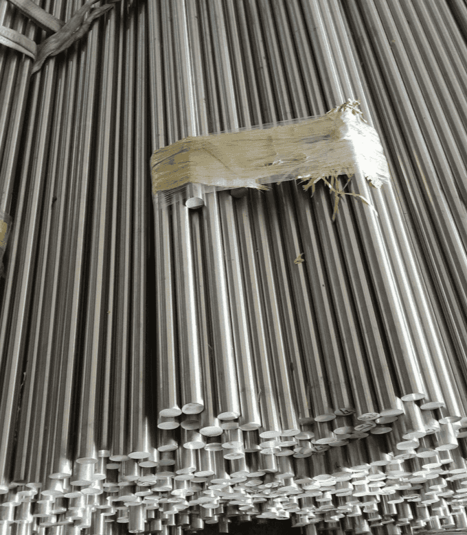 A stack of polished cylindrical steel bars tied together.