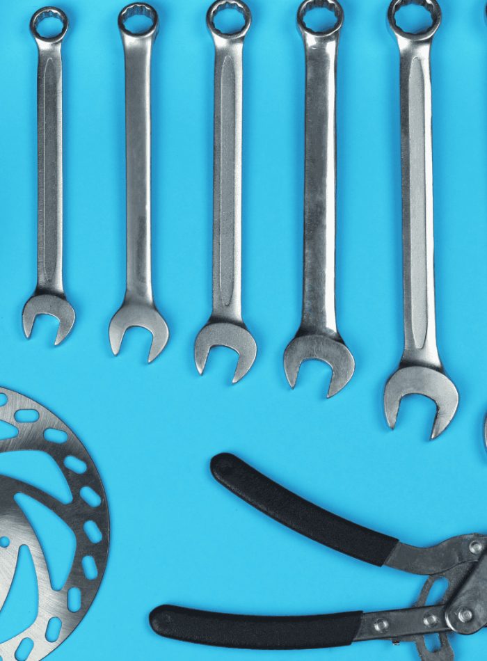 Set of wrenches and tools on a blue background.