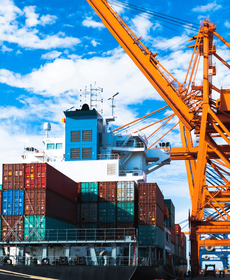 Cargo ship being loaded at a port with cranes made of advanced high strength steel