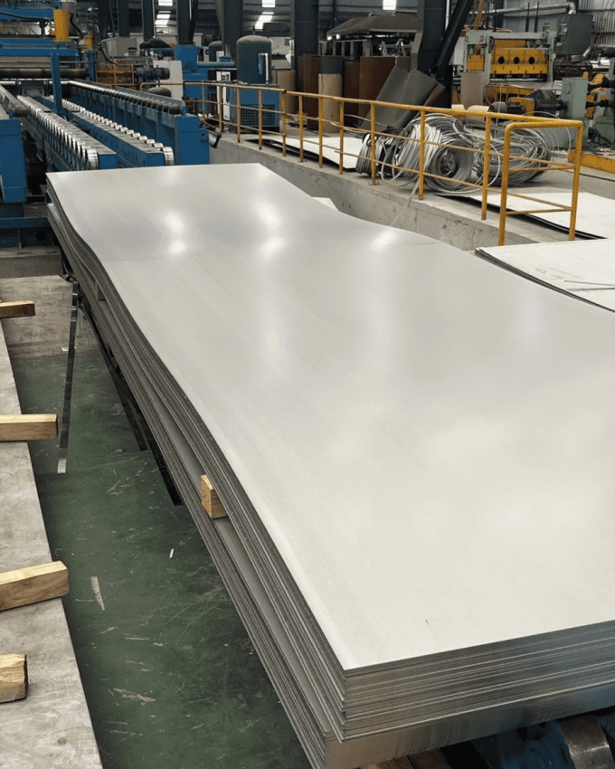 A stack of processed ultra high strength steel sheets ready for manufacturing, highlighting its strength and precision.